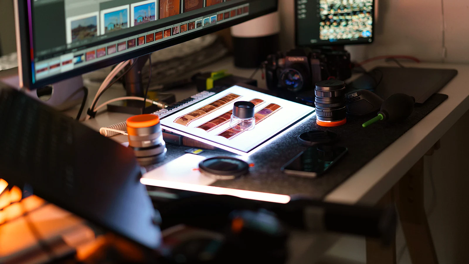 Professional photo editing workstation with film scans and camera gear